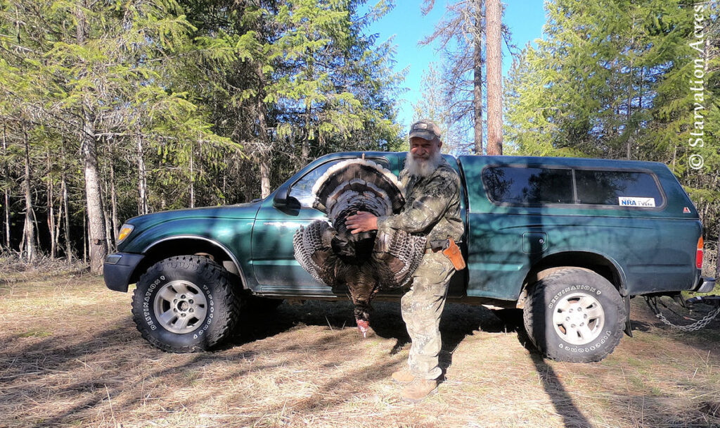 Holding my wild turkey of 2021 in front of my 2000 Toyota Tacoma.