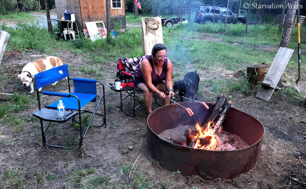 Naomi roasting hotdogs.