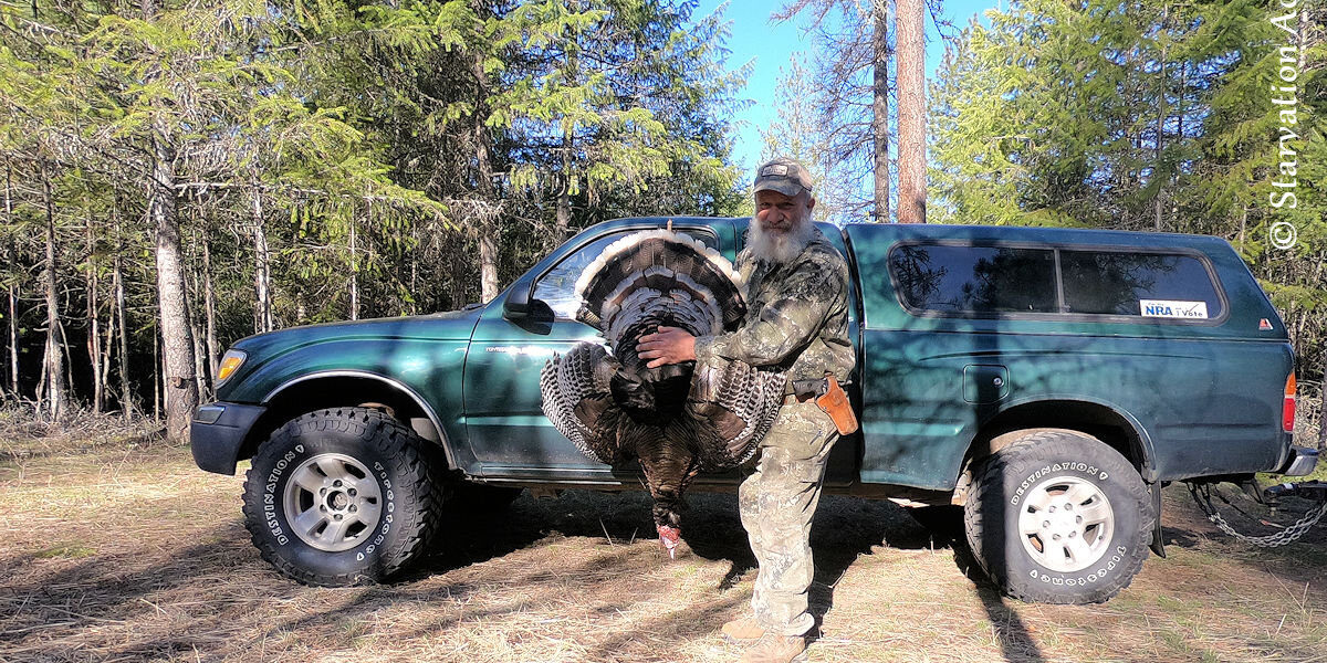 Holding my wild turkey of 2021 in front of my 2000 Toyota Tacoma.